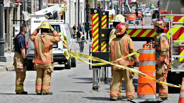 Fire watch guard overseeing a construction site with active welding and fire hazards
